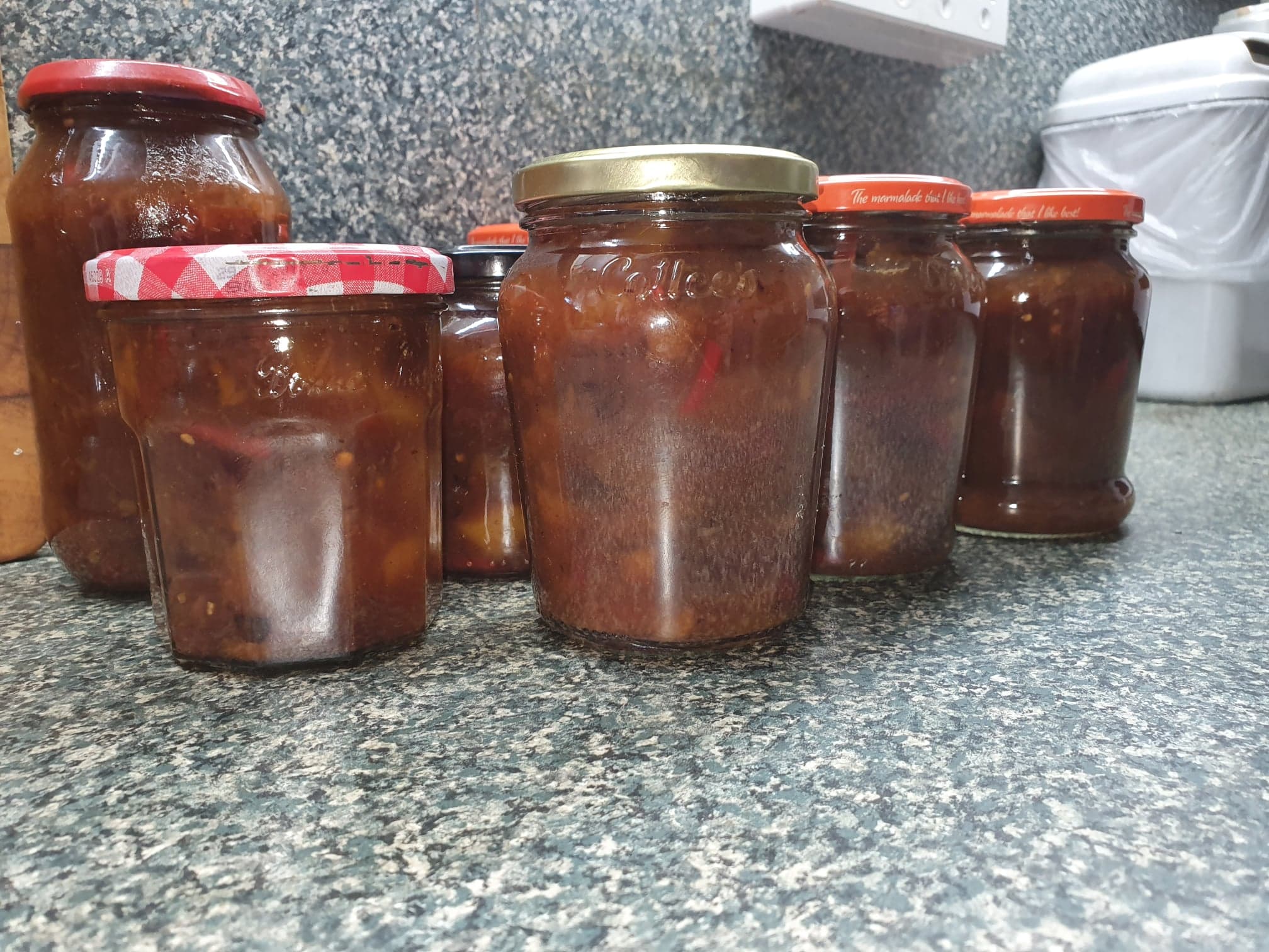 Image of jars of various shapes and sizes filled with chutney